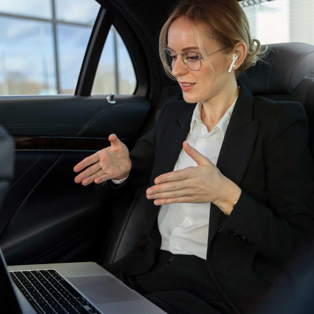 Elegantly chauffeured car with a satisfied business customer in the backseat.